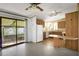 Kitchen with wood cabinets, white appliances, and breakfast bar at 450 Tivoli Park Dr, Davenport, FL 33897