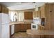 Galley kitchen with wood cabinets and a corner sink at 450 Tivoli Park Dr, Davenport, FL 33897