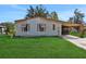 Single-wide mobile home with carport and well-maintained lawn at 450 Tivoli Park Dr, Davenport, FL 33897