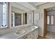Bathroom with double vanity and a large mirror at 450 Tivoli Park Dr, Davenport, FL 33897