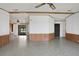 Open living room with tile floors and wood paneling at 450 Tivoli Park Dr, Davenport, FL 33897
