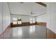 Spacious living room with wood-paneled walls and tile floors at 450 Tivoli Park Dr, Davenport, FL 33897