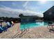 Community pool with lounge chairs and brick patio at 4160 Pershing Pointe Pl # 1, Orlando, FL 32822