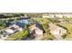 Aerial view of a community with houses, a pond, and green spaces at 223 Lake Davenport Estates, Davenport, FL 33897