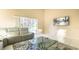Living room with grey couch, coffee table, and sliding doors leading to a pool view at 223 Lake Davenport Estates, Davenport, FL 33897