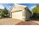 Exterior view of a two-car garage with additional storage space at 223 Lake Davenport Estates, Davenport, FL 33897