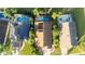 Aerial view showcasing three homes with pools and solar panels at 223 Lake Davenport Estates, Davenport, FL 33897