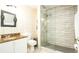 Bathroom with granite countertop, shower, and tile flooring at 223 Lake Davenport Estates, Davenport, FL 33897