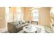 Living room with gray couch, coffee table, and large window at 223 Lake Davenport Estates, Davenport, FL 33897