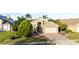 Aerial view of a tan house with a two-car garage at 223 Lake Davenport Estates, Davenport, FL 33897