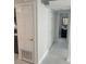 Clean hallway with white walls and tiled floor at 2727 W Oak Ridge Rd # 3, Orlando, FL 32809