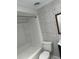 Updated bathroom with white fixtures and brick wall at 2727 W Oak Ridge Rd # 3, Orlando, FL 32809