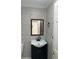 Bathroom with dark vanity and brick-look wallpaper at 2727 W Oak Ridge Rd # 3, Orlando, FL 32809