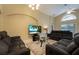 Spacious living room with comfortable seating and large TV at 523 Balmoral Dr, Davenport, FL 33896