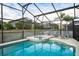 Inviting screened pool and spa with patio furniture at 523 Balmoral Dr, Davenport, FL 33896