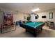 Game room features pool table, air hockey, and basketball game at 523 Balmoral Dr, Davenport, FL 33896