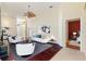 Living room with hardwood floors, a white couch, and a view into the dining area at 520 Vista Oaks Way, Davenport, FL 33837
