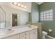 Double vanity bathroom with a glass block window and a toilet at 520 Vista Oaks Way, Davenport, FL 33837