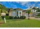 Well-maintained house with a manicured lawn and palm trees at 520 Vista Oaks Way, Davenport, FL 33837
