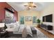 Main bedroom with a comfortable bed, accent wall and plenty of natural light at 520 Vista Oaks Way, Davenport, FL 33837