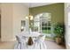 Bright dining room with a round table and chairs, offering a view of the backyard at 520 Vista Oaks Way, Davenport, FL 33837