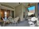 Relaxing screened porch with wicker furniture and access to the house at 520 Vista Oaks Way, Davenport, FL 33837