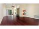 Spacious living room featuring hardwood floors and a view into the kitchen and backyard at 520 Vista Oaks Way, Davenport, FL 33837