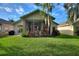 Screened patio with a lush green lawn at 520 Vista Oaks Way, Davenport, FL 33837