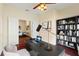 Home office with a desk, built-in shelving and view of dining area at 520 Vista Oaks Way, Davenport, FL 33837