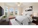 Spacious bedroom with wood flooring, large windows, and a striped bed at 520 Vista Oaks Way, Davenport, FL 33837