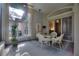 Screened porch with seating area, ceiling fan and view of the backyard at 520 Vista Oaks Way, Davenport, FL 33837