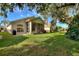 House with a screened patio and lush green lawn at 520 Vista Oaks Way, Davenport, FL 33837