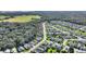 Aerial view of home nestled in a community with lush landscaping and nearby water at 520 Vista Oaks Way, Davenport, FL 33837