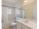 Clean bathroom with a shower/tub combo, single sink vanity, and a toilet at 520 Vista Oaks Way, Davenport, FL 33837