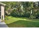 Lush green backyard with mature trees and plants at 520 Vista Oaks Way, Davenport, FL 33837