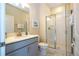 Bathroom with a gray vanity, shower, and white tile at 4845 Romeo Cir, Kissimmee, FL 34746
