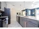 Modern kitchen with gray cabinets, quartz countertops, and stainless steel appliances at 4845 Romeo Cir, Kissimmee, FL 34746