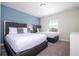 Bedroom with two twin beds, closet, and blue accent wall at 4845 Romeo Cir, Kissimmee, FL 34746