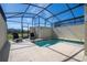 Private screened pool with lounge chairs and a view at 4845 Romeo Cir, Kissimmee, FL 34746