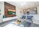 Modern living room with a large TV, wood feature wall, and comfortable seating at 4845 Romeo Cir, Kissimmee, FL 34746