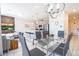 Open concept dining area with glass table and modern chandelier at 4845 Romeo Cir, Kissimmee, FL 34746