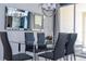 Modern dining room featuring a glass table and six dark gray chairs at 4845 Romeo Cir, Kissimmee, FL 34746