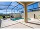 Enclosed private pool and patio with lounge chairs at 4845 Romeo Cir, Kissimmee, FL 34746