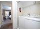 Bright laundry room with washer, dryer, and extra shelving at 4845 Romeo Cir, Kissimmee, FL 34746