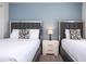 Bedroom with two twin-size beds and a nightstand at 4845 Romeo Cir, Kissimmee, FL 34746