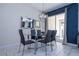 Bright dining room with glass table, six chairs, and modern chandelier at 4845 Romeo Cir, Kissimmee, FL 34746