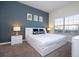 Main bedroom with gray accent wall and a king-size bed at 4845 Romeo Cir, Kissimmee, FL 34746