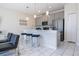 Modern kitchen with gray cabinets, quartz countertops, and breakfast bar at 4845 Romeo Cir, Kissimmee, FL 34746