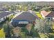 Aerial perspective of a house's backyard with a screened-in patio and landscaping at 513 Viterra Ct, Kissimmee, FL 34759