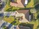 Aerial view of property, featuring a tiled roof, landscaped yard, and driveway at 513 Viterra Ct, Kissimmee, FL 34759